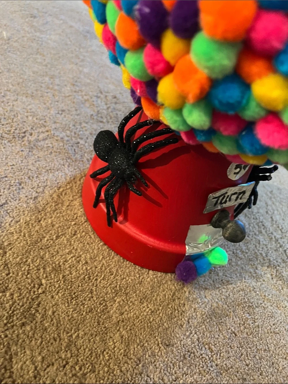 Red Gumball Toy Machine with Multicolor Pom-Pom Cover with Spiders